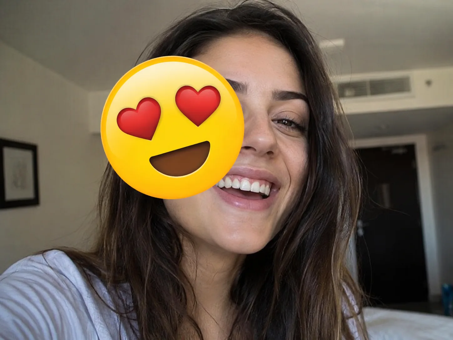 Before removing a heart-eyes emoji sticker covering a portrait face